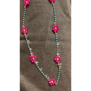this view shows pink flowers connected by blue beading on a gold wire!