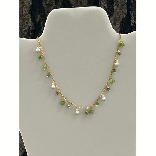 shows the gold chain with green and white beaded charms