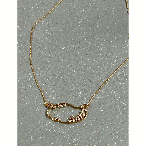 asymmetrical open oval pendant with crystal studs on gold chain