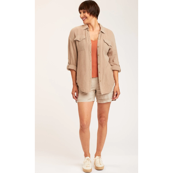 button down shirt with front unbuttoned and open in a light tan color and long rolled up sleeves