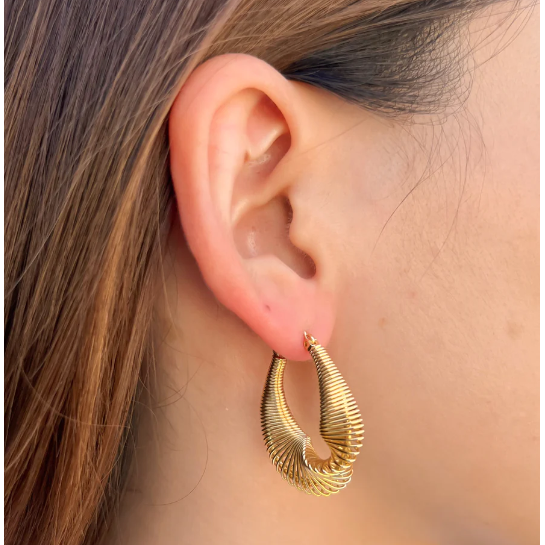 slinky gold earring hoop pictured on earlobe