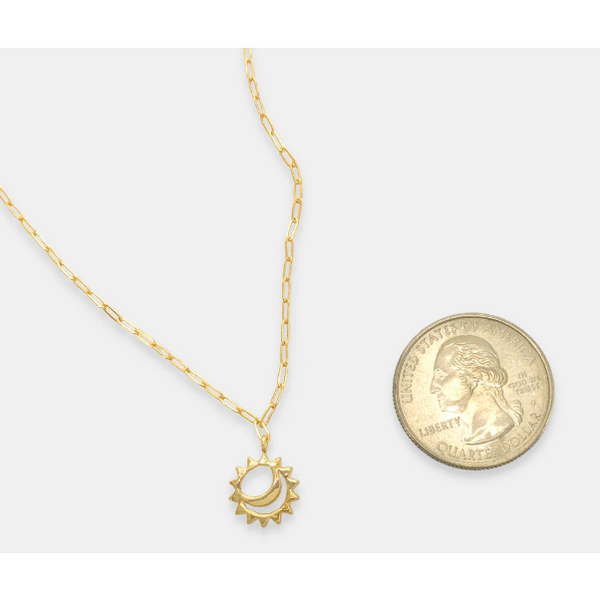 flat lay sun moon pendant with chain placed next to a quarter for sizing 