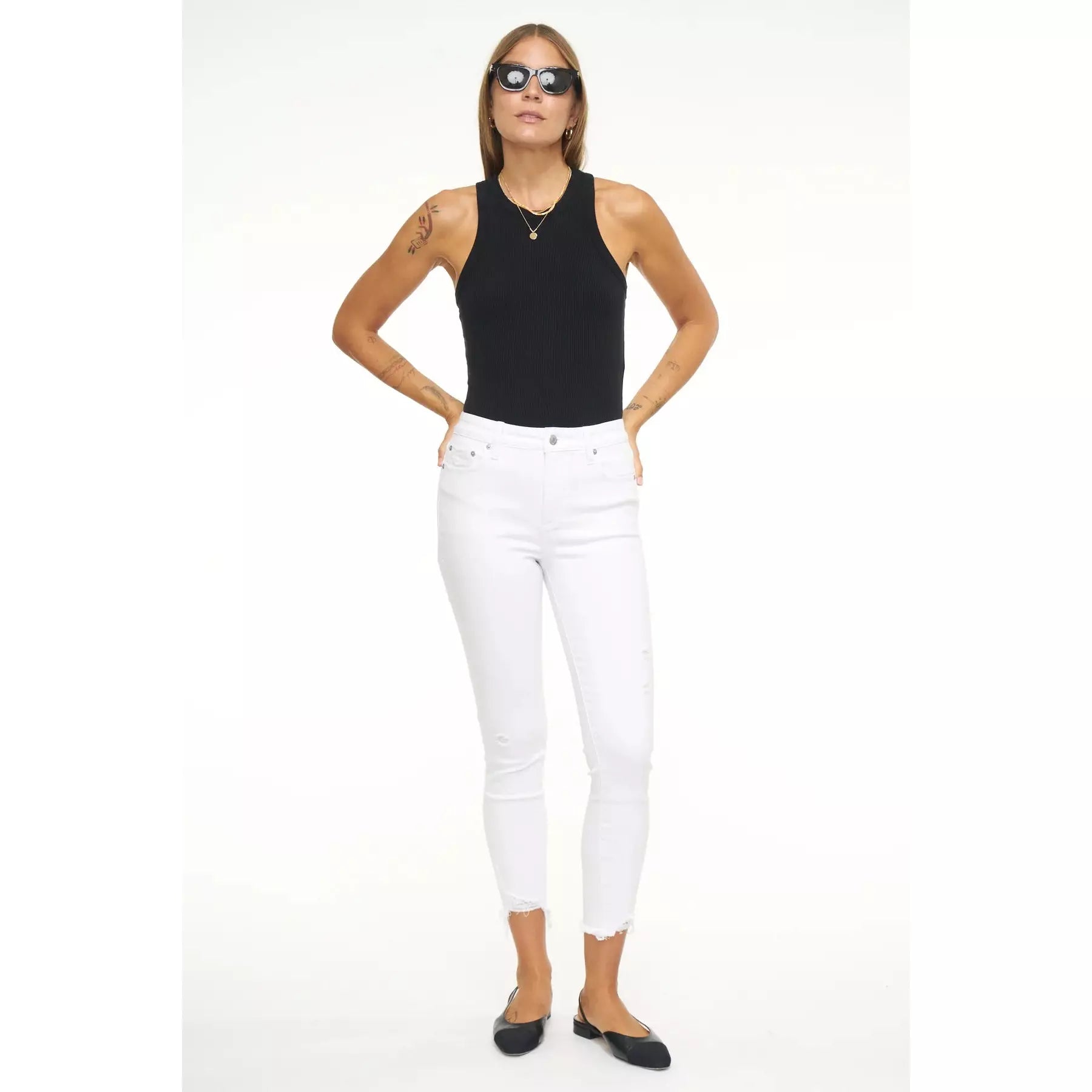 front view white skinny jeans with light distressing and unfinished hemline