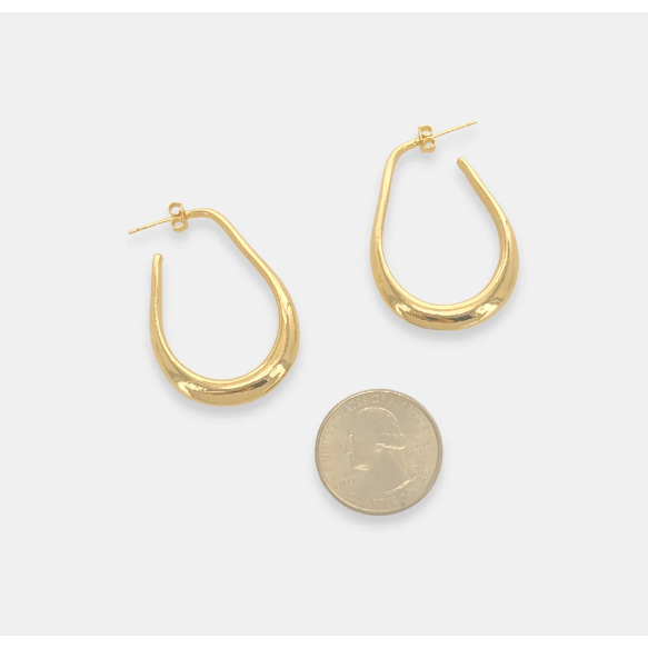 flat lay view of gold teardrop hoop earring pictured next to a quarter