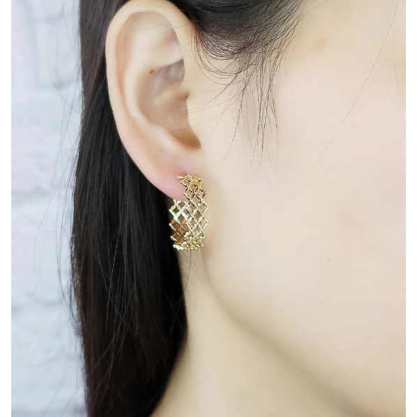 Small waffle stamped gold earring pictured on ear